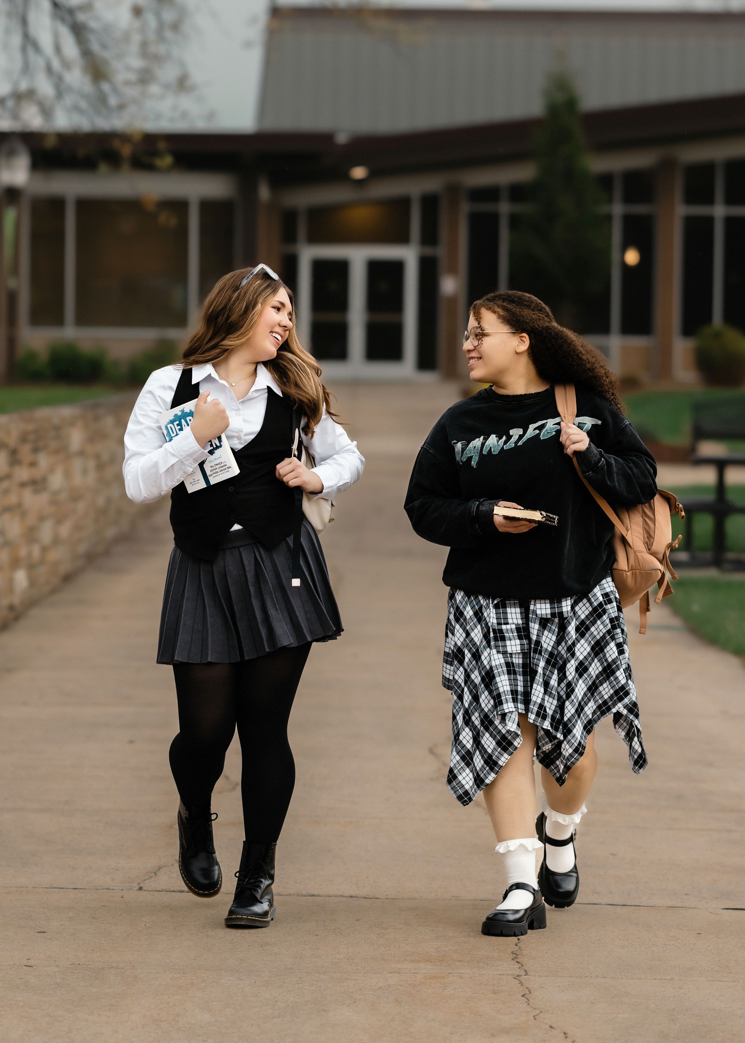 Candid moments of friends in coordinated black and white outfits dancing outside.