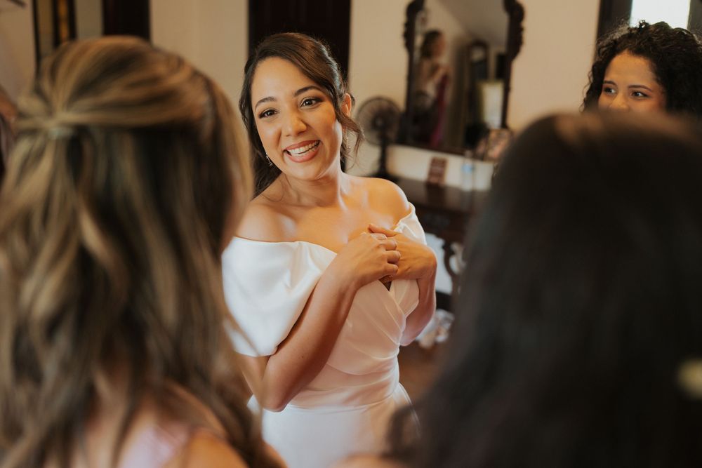 Candid moments of wedding preparations with soft natural lighting in a rustic indoor setting.