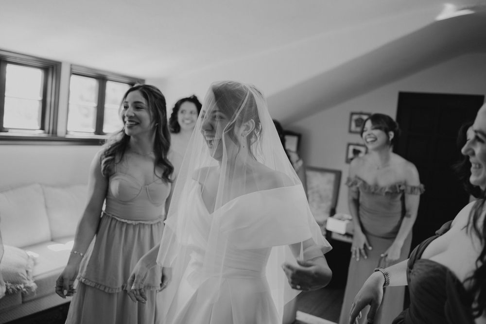 A series of candid moments captured during wedding preparations showing bridesmaids and bridal gowns in a sunlit room.