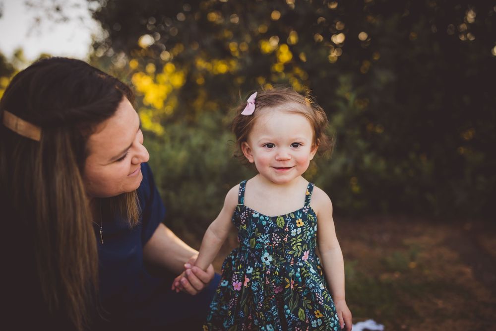 A series of connected photos showing a toddler in a floral dress playing outdoors during golden hour.