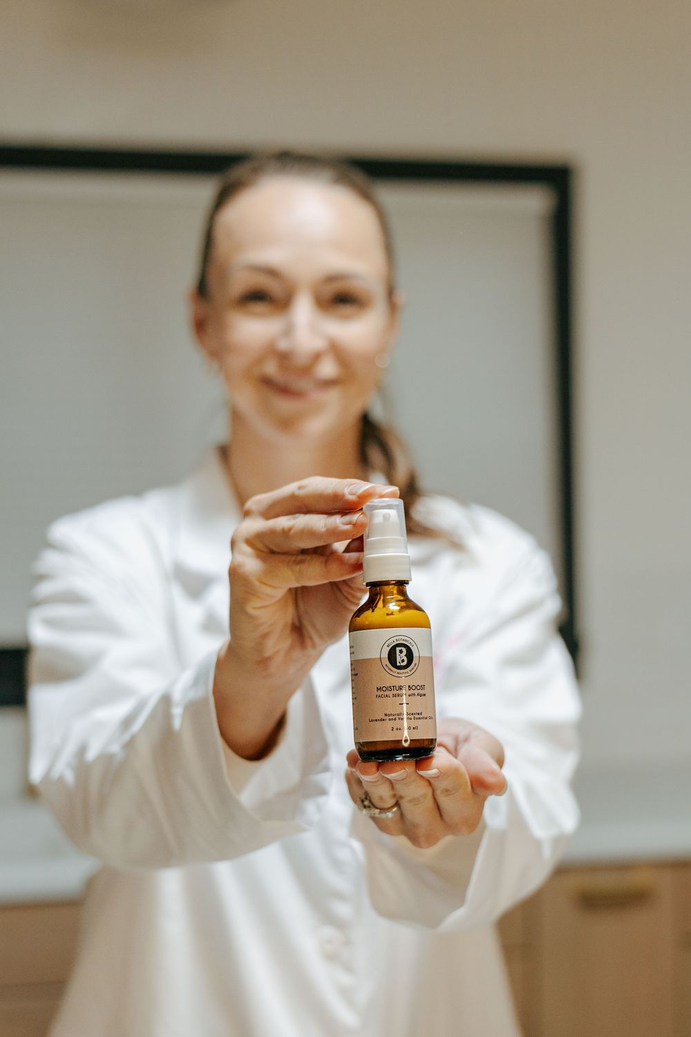 A person in white lab coat holding amber glass bottles and jars in a sequence of product shots.