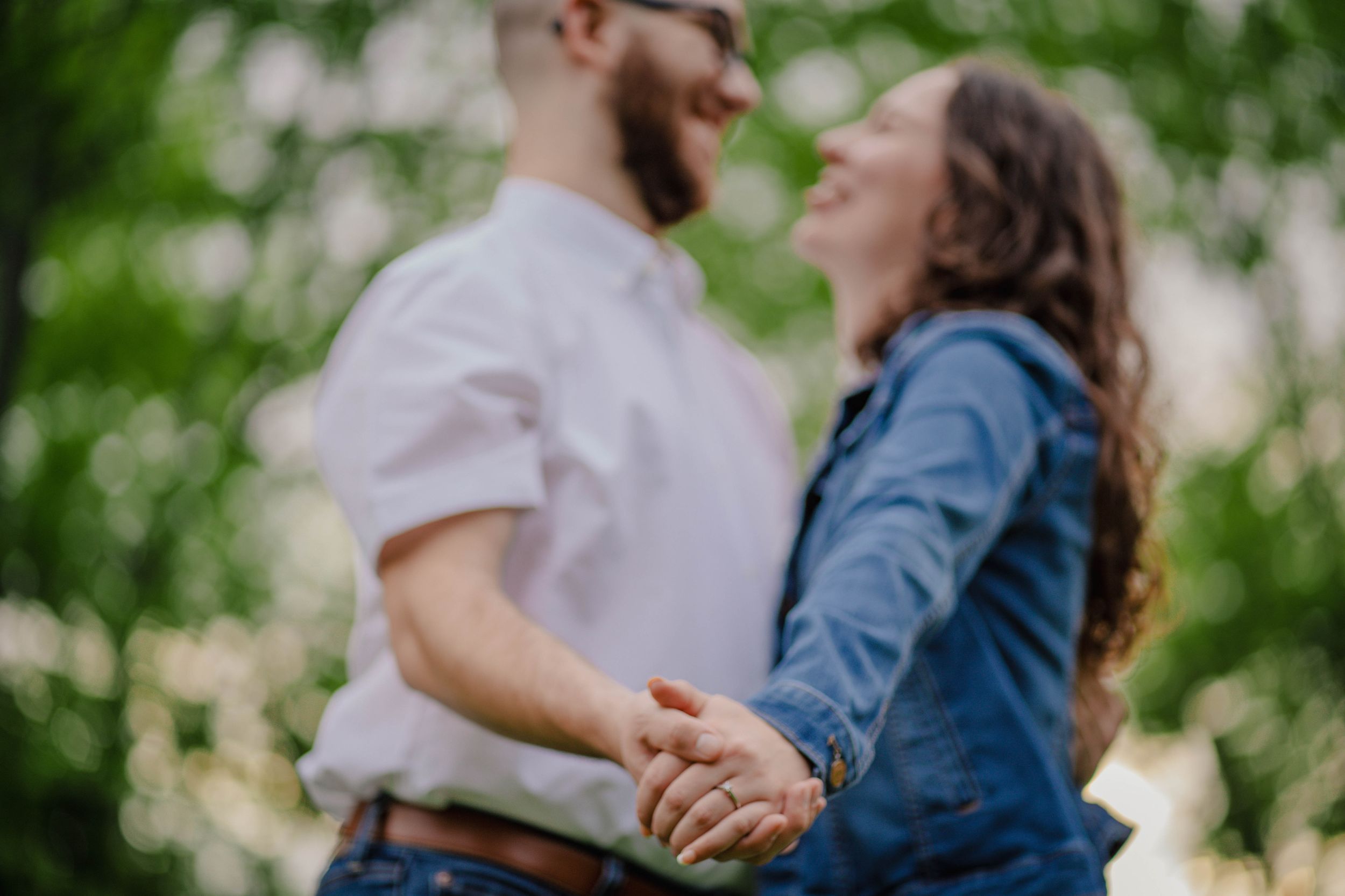 A romantic outdoor portrait captures a tender moment between a couple in natural lighting.