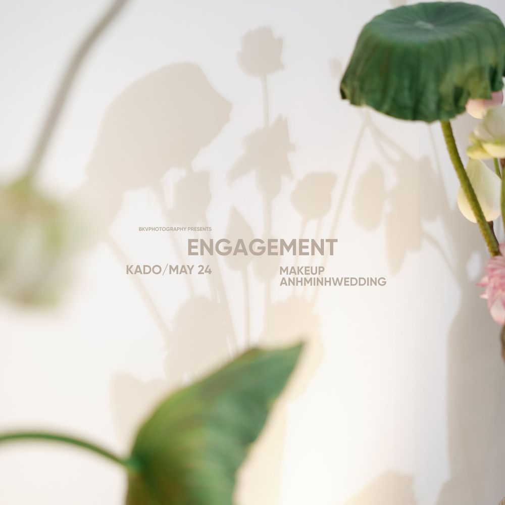 Minimalist engagement announcement text overlay on a soft, blurred floral background.