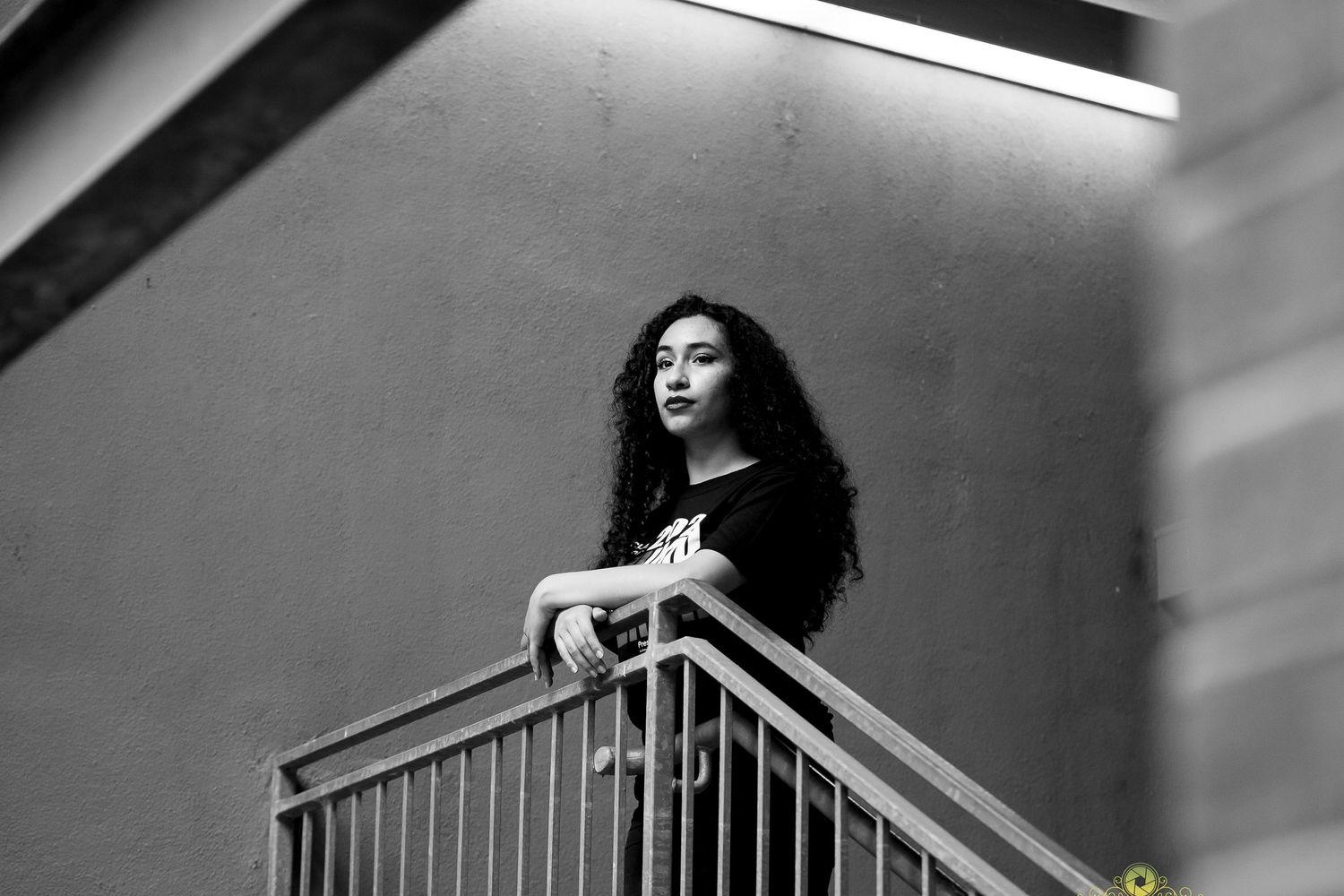 A dramatic black and white portrait taken on a staircase.