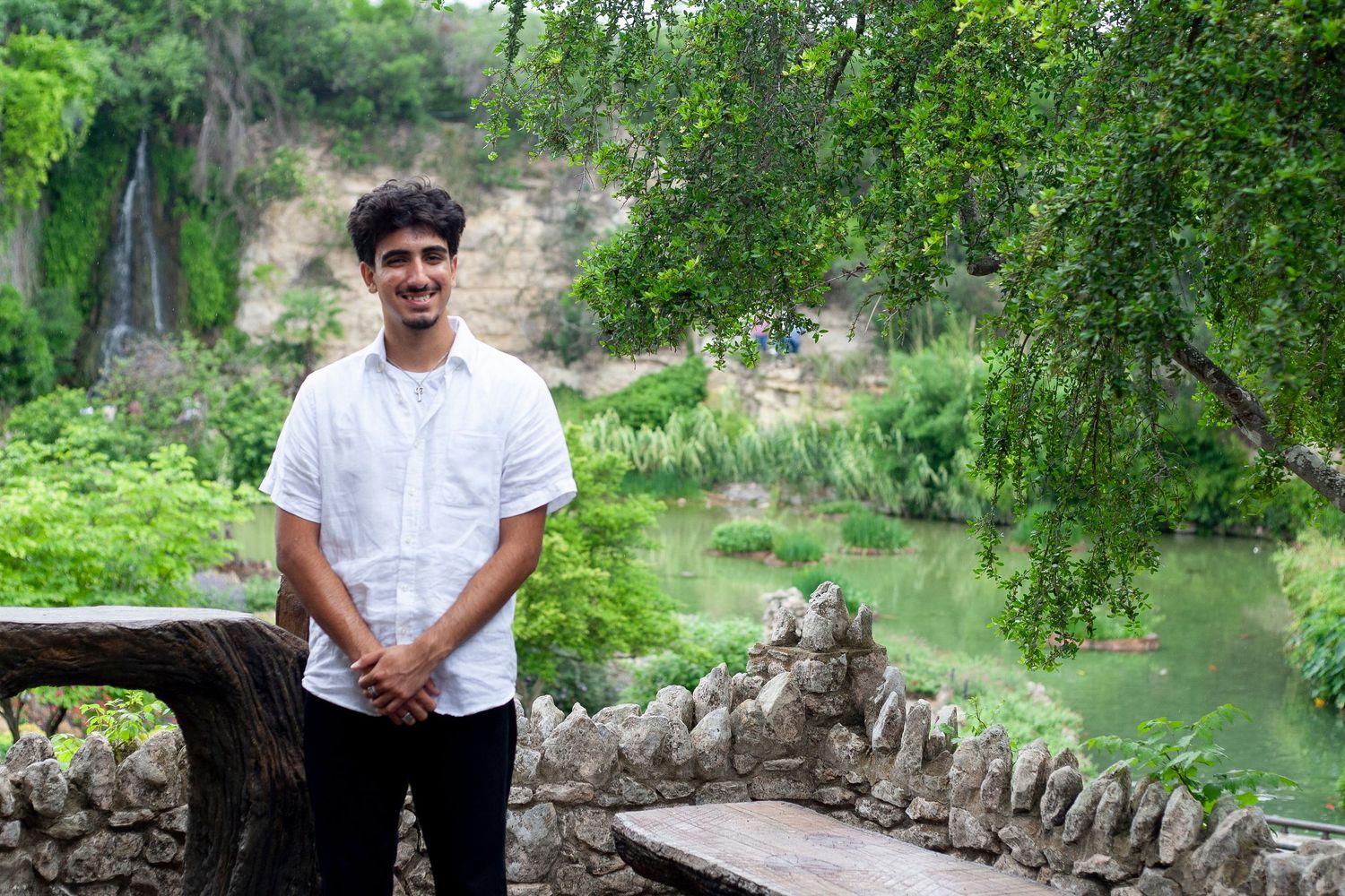 A scenic view at Japanese Tea gar den in San Antonio TX with stone wall and water feature in background.