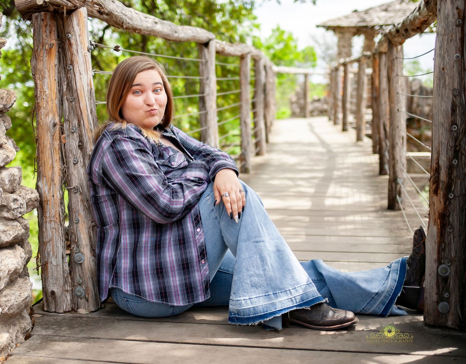 Casual senior photo session on wooden walkway with rustic railing.