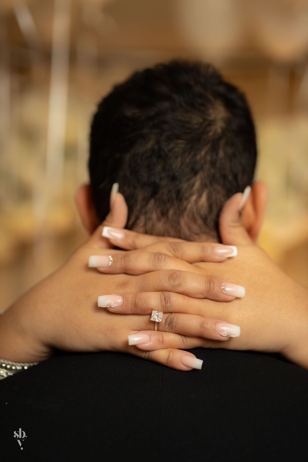 Close-up sequence of hands with French manicured nails clasped behind neck showing rose gold ring.