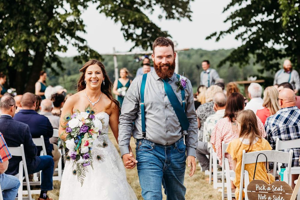 bride and groom leaving their ceremony with smiles