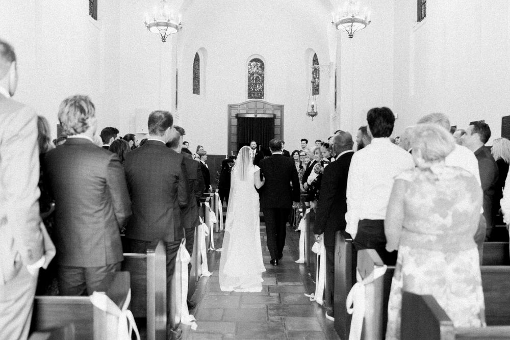 Presidio Chapel wedding ceremony photos. Father and daughter walking down the ailes.