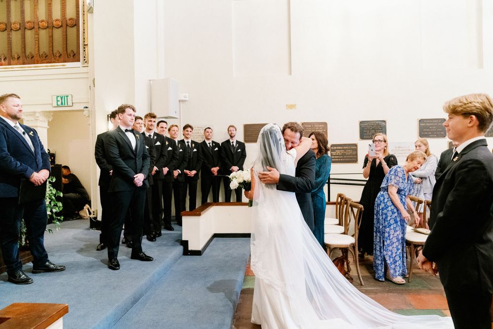 Presidio Chapel wedding ceremony photos. Father and daughter walking down the ailes.
