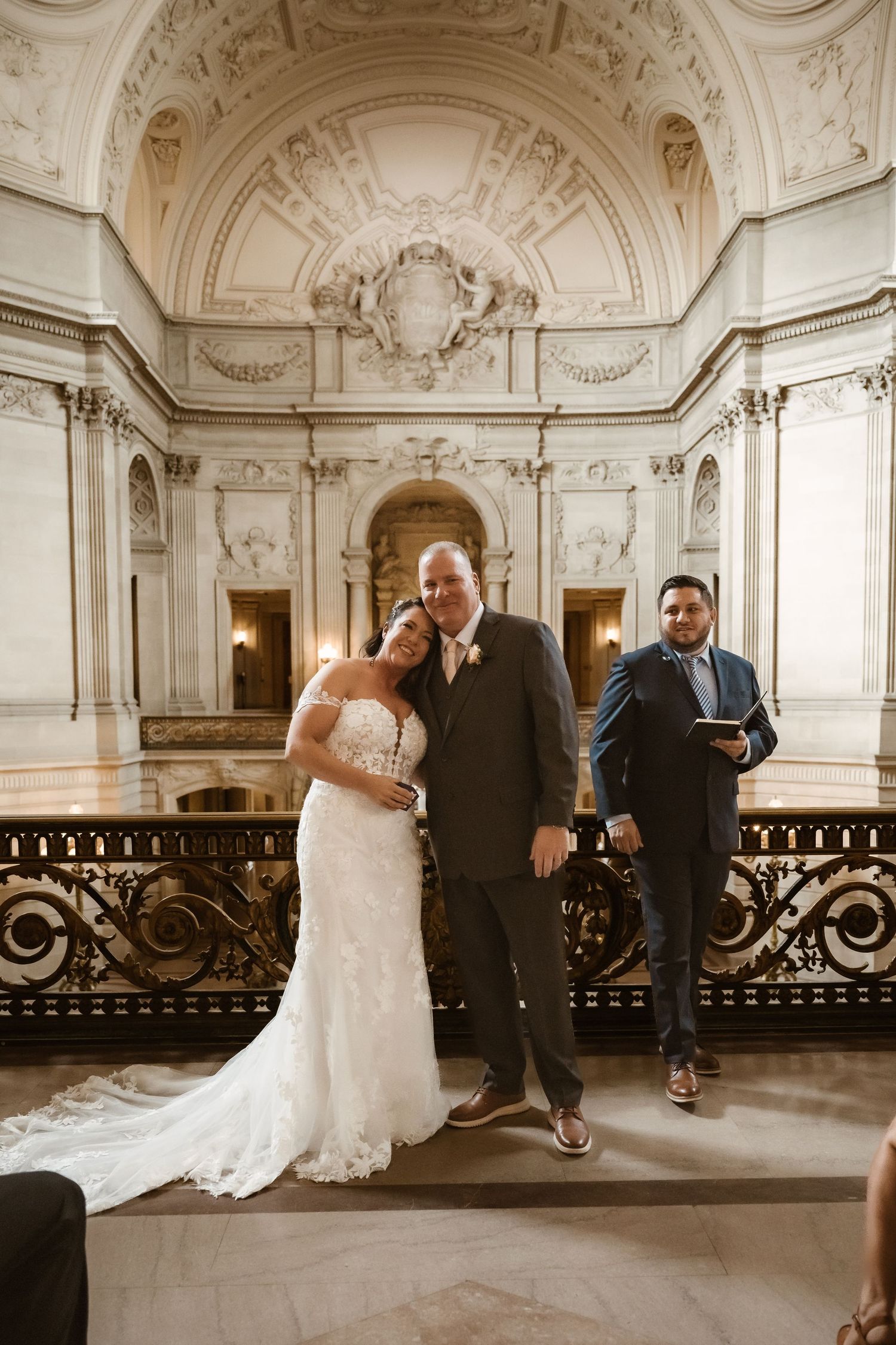 Wedding ceremony moment captured in historic venue with classical architectural details.