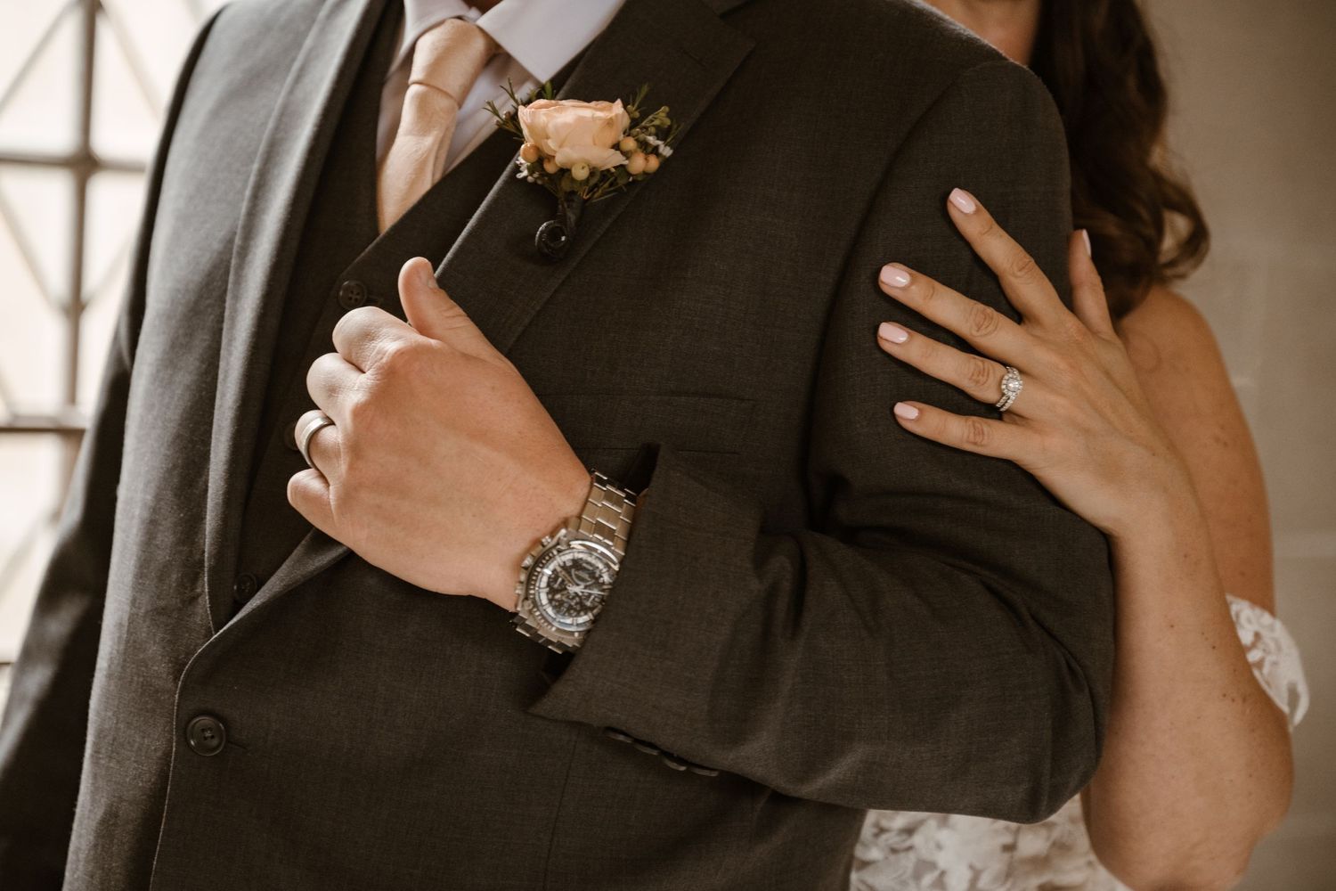 Close-up of wedding couple embracing in romantic moment.