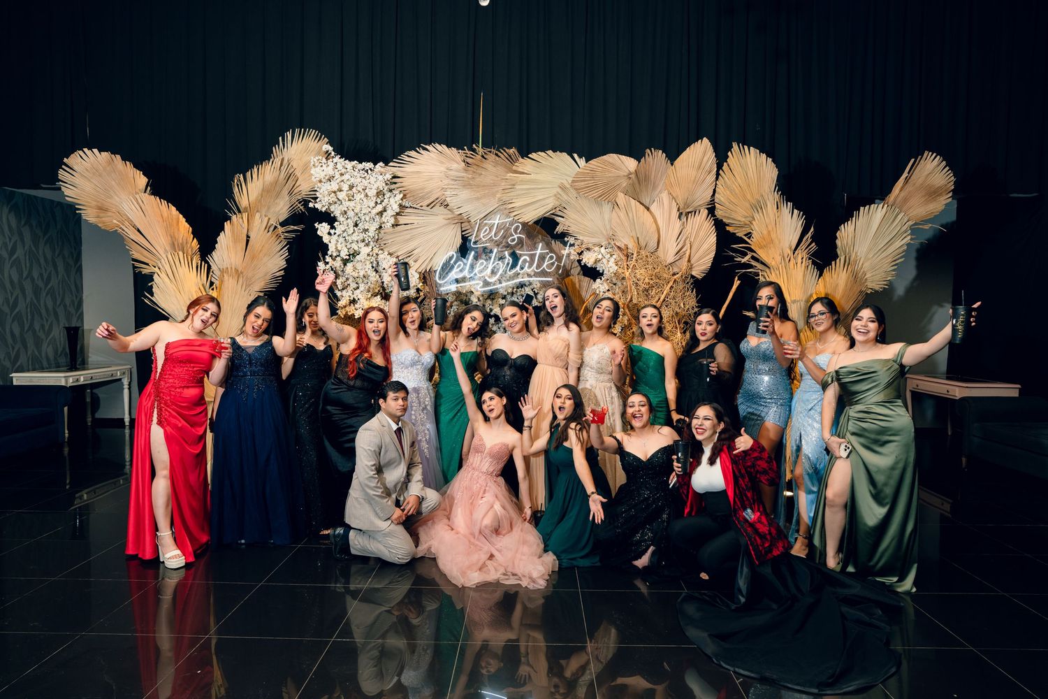 Large group of formal event attendees posing together on stage.