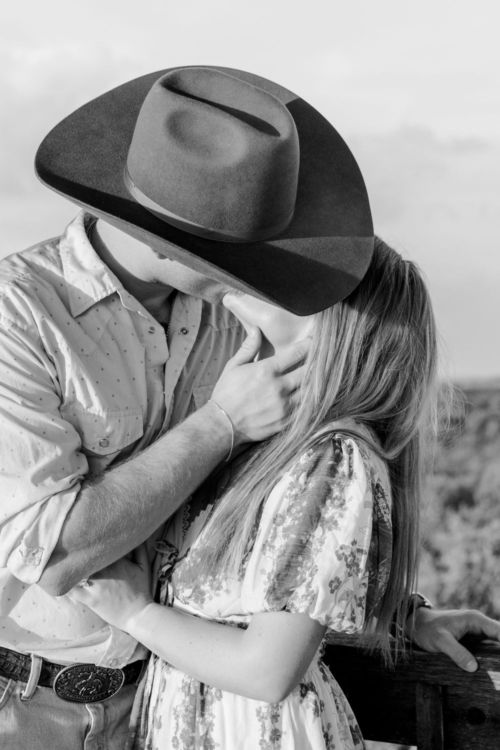 Couple holding each other close after a surprise proposal in Texas Hill Country.