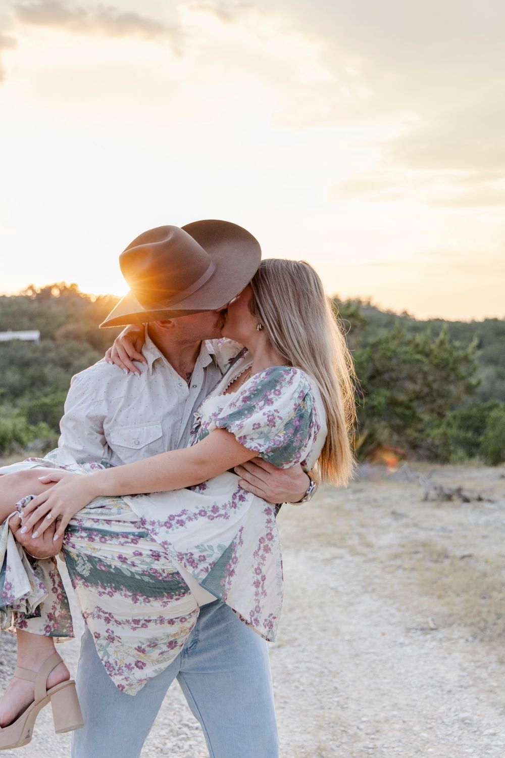 Couple walking down candlelit walkway after engagement in Dripping Springs, Texas.