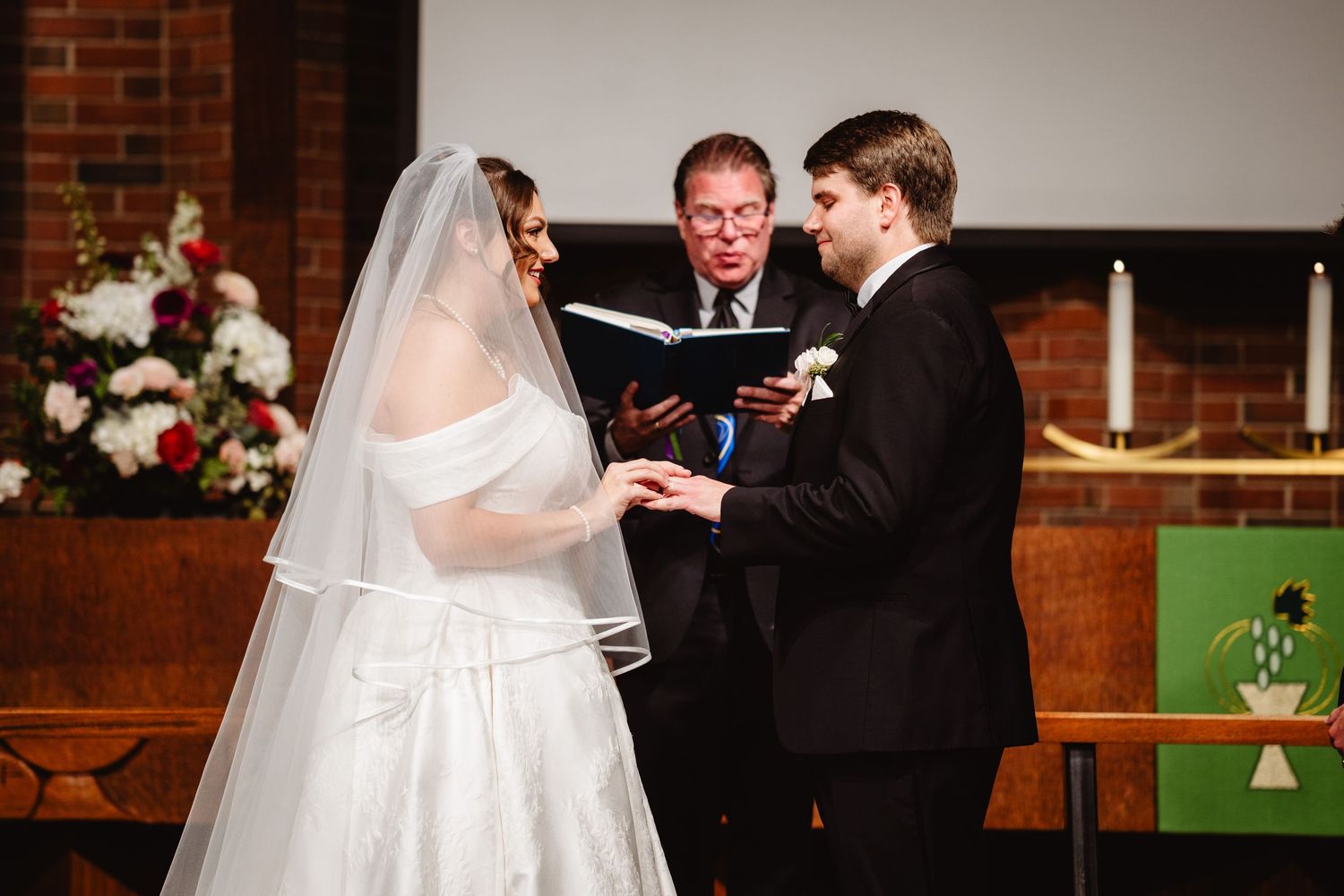 A collection of romantic moments during an indoor wedding ceremony at a brick-walled venue with warm lighting.