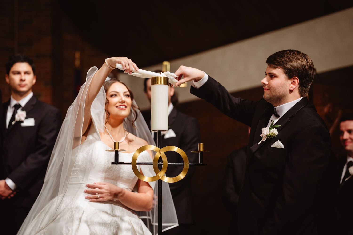 Bride and groom share their first dance together at an elegant candlelit wedding reception.