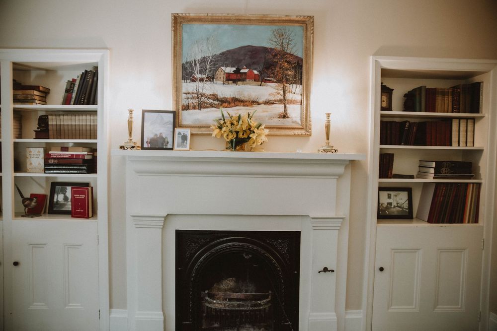 Interior view of a white built-in bookshelf and cabinet system with paneled doors and decorative moldings.