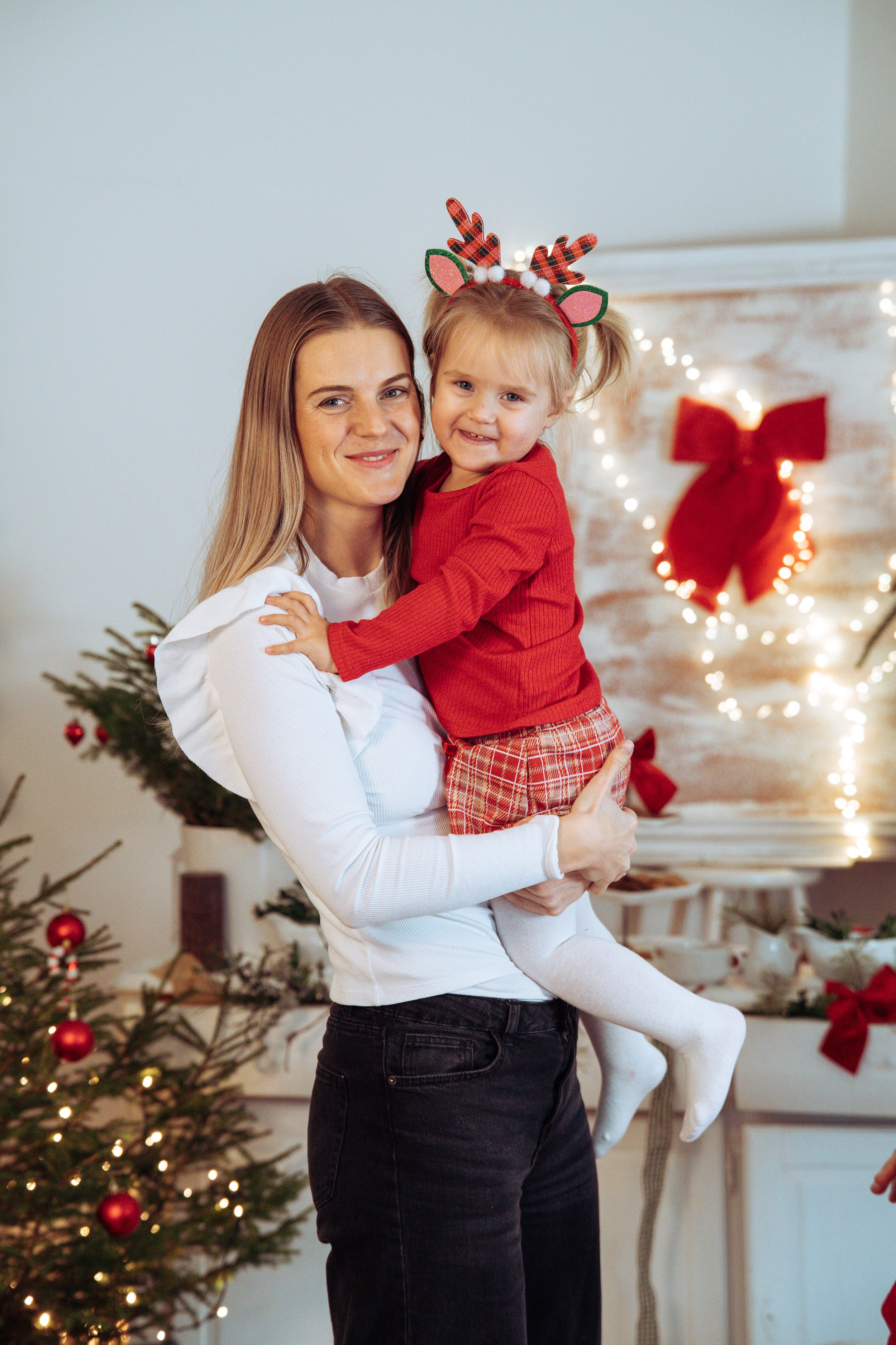 Holiday photos with Christmas decorations, lights, and a decorated tree in the background.