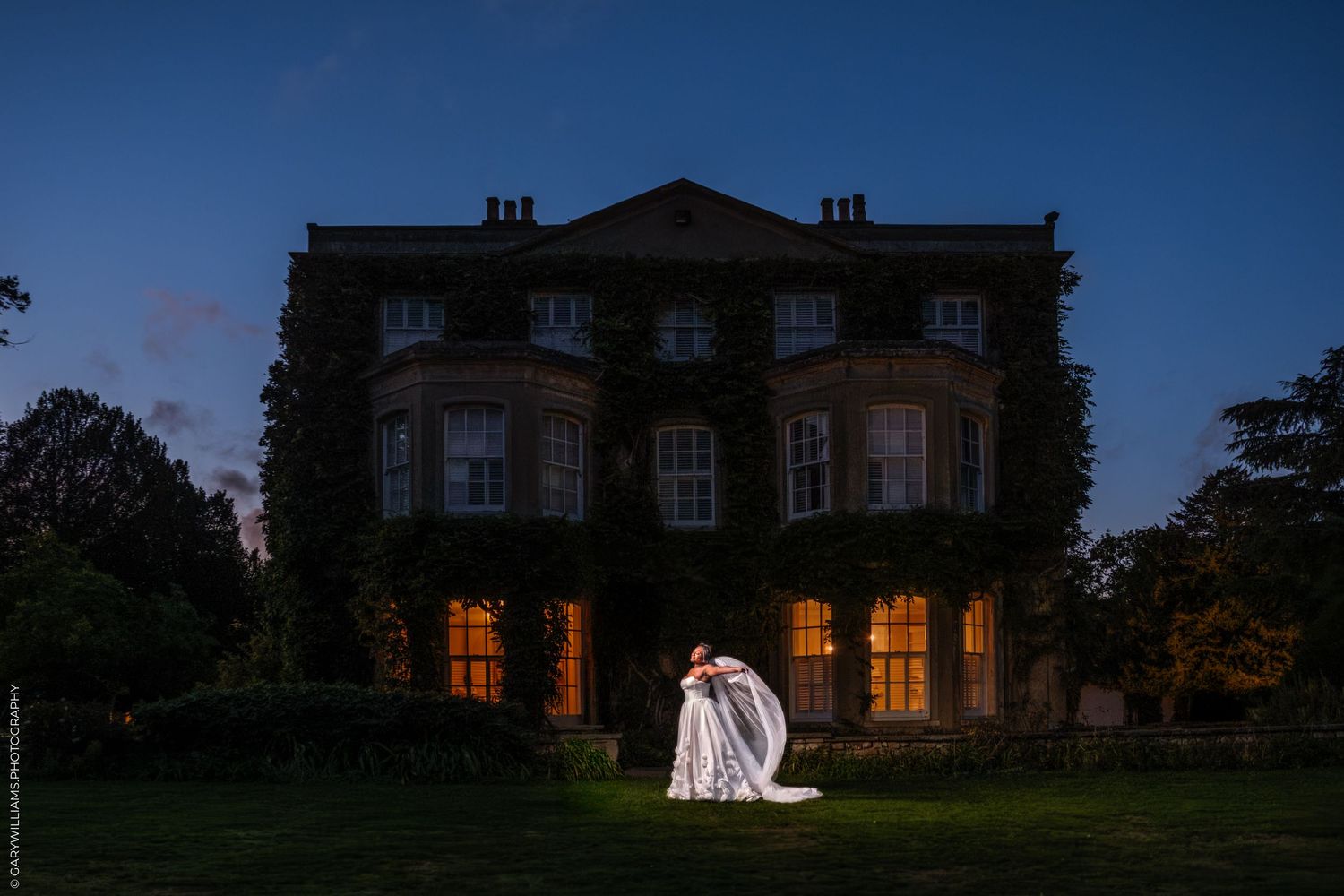 A sequence of five photos showing a grand manor house at dusk with glowing windows and illuminated wedding scenes.