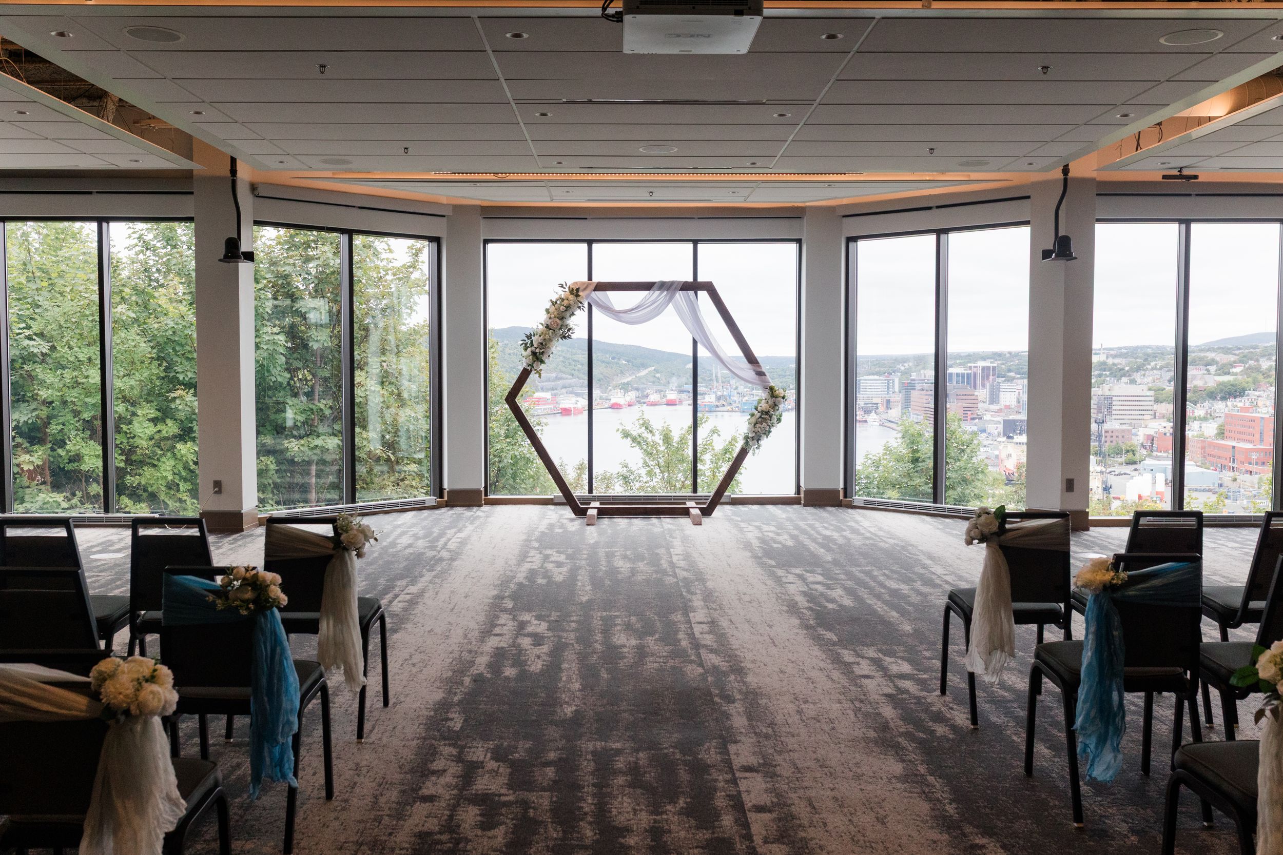 Panoramic sequence showing modern office interior with expansive windows overlooking a cityscape in the distance.