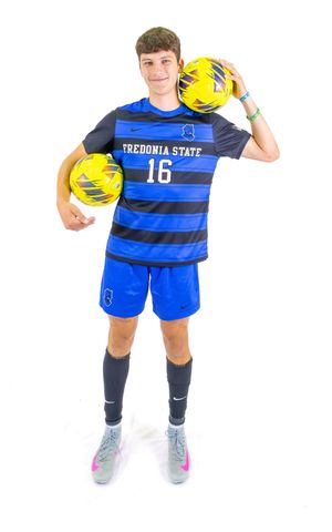 Fredonia State soccer player number 16 holding two yellow soccer balls in striped blue uniform.