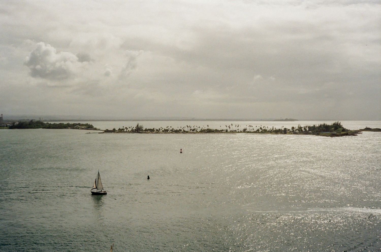 Panoramic coastal view of scenic island mountains and waterfront cities stretching along the Caribbean shoreline.