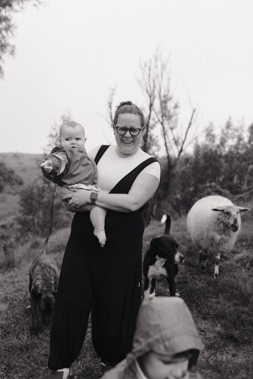 Candid black and white photo of playful moments outdoors with pets.