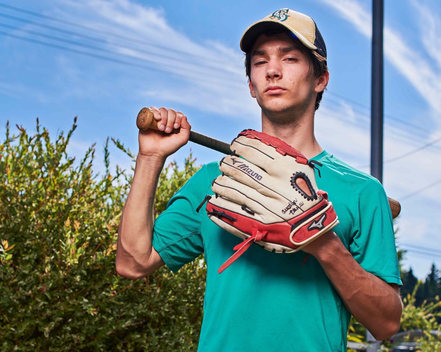Unretouched portrait of high school student for baseball portrait with objects in background