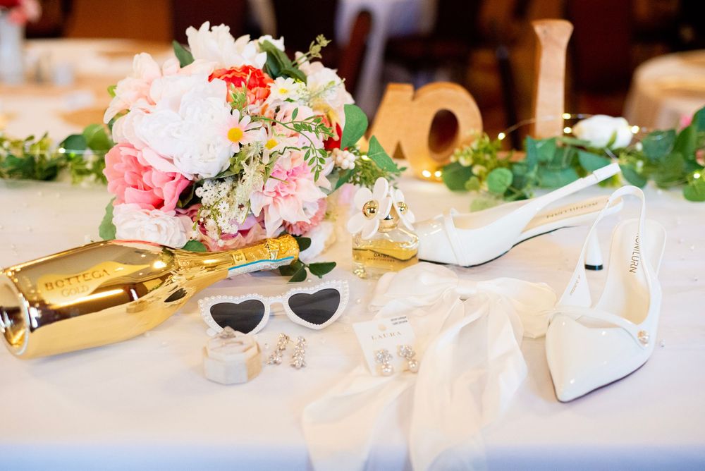 Elegant wedding reception table decorated with pink floral arrangements and place settings.