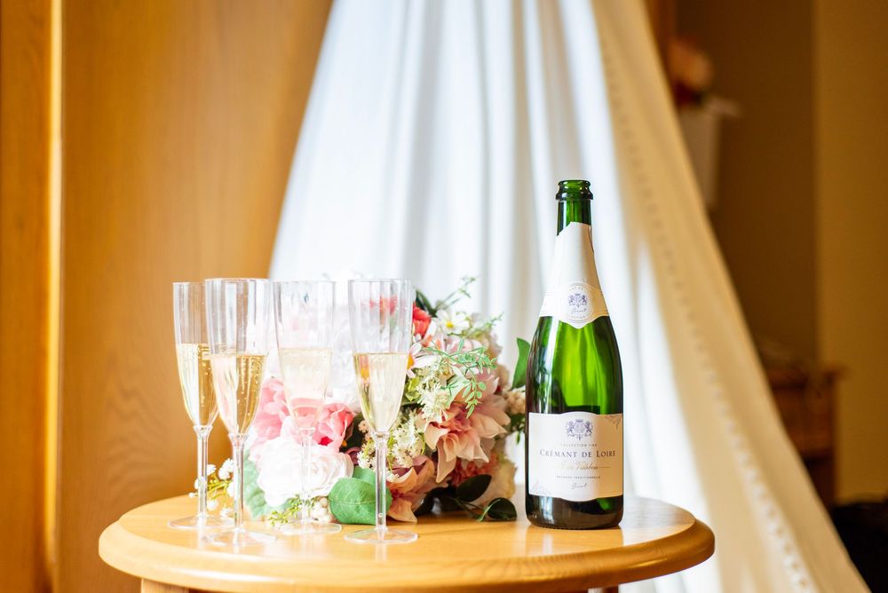 Champagne bottles and glasses arranged on an elegant wedding reception table.