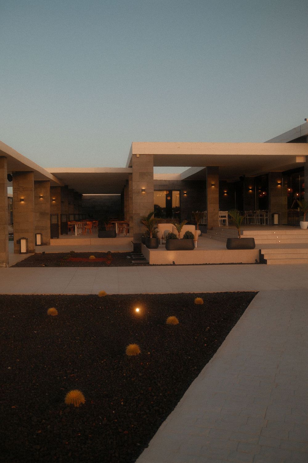 Modern desert building with clean lines and geometric shapes at dusk.