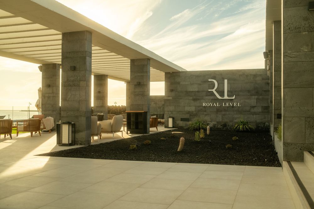 Minimalist outdoor terrace with modern architecture and dramatic sky views.