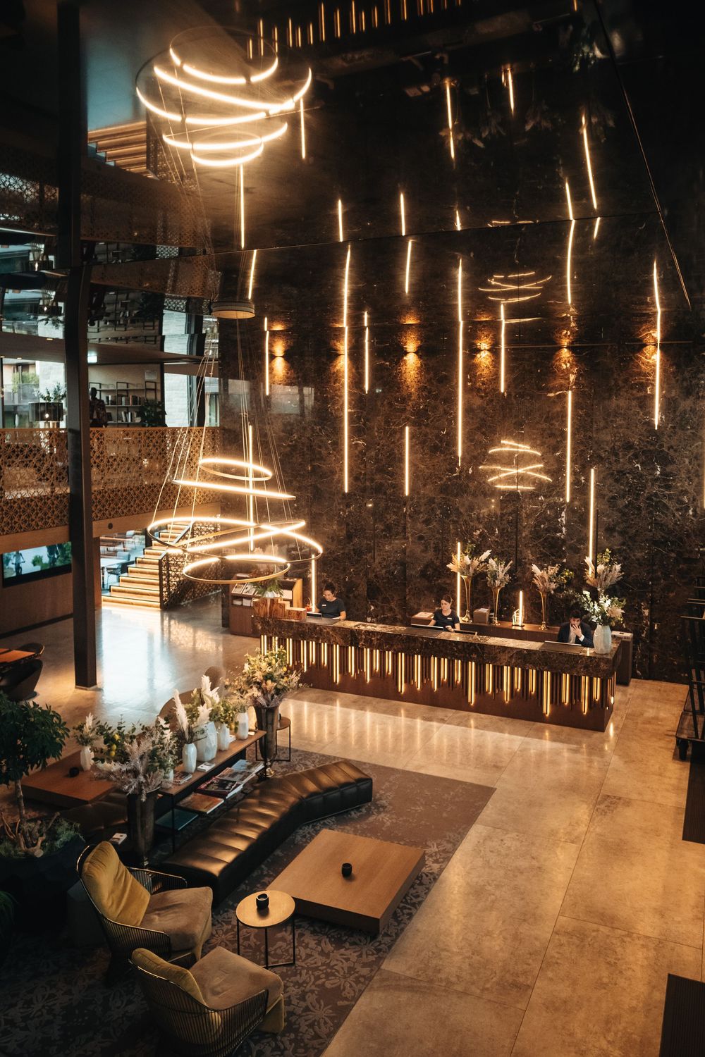 Stylish lounge area with suspended light fixtures and exposed brick walls creating a warm ambiance.