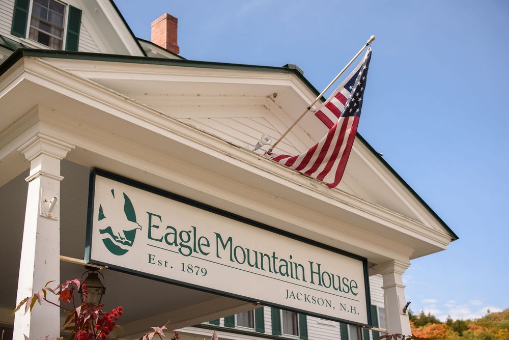 Exterior of Eagle Mountain House with American flag and classic New England architecture.