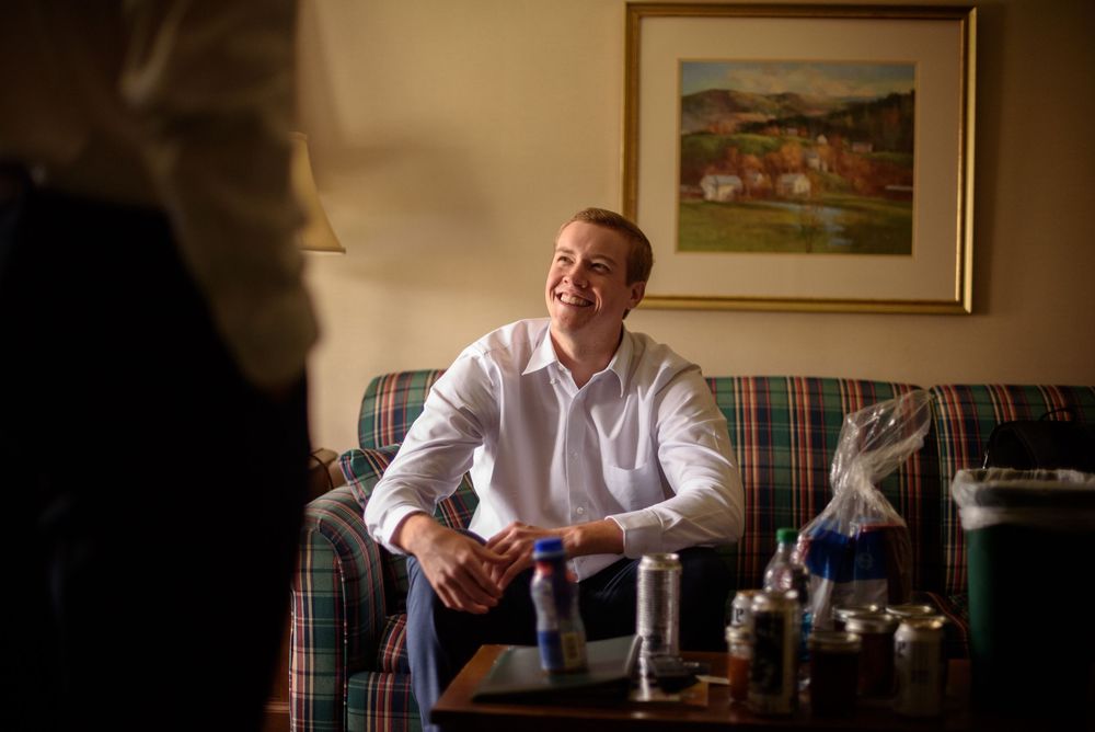 Candid moments captured in warm lighting within a traditional hotel room.