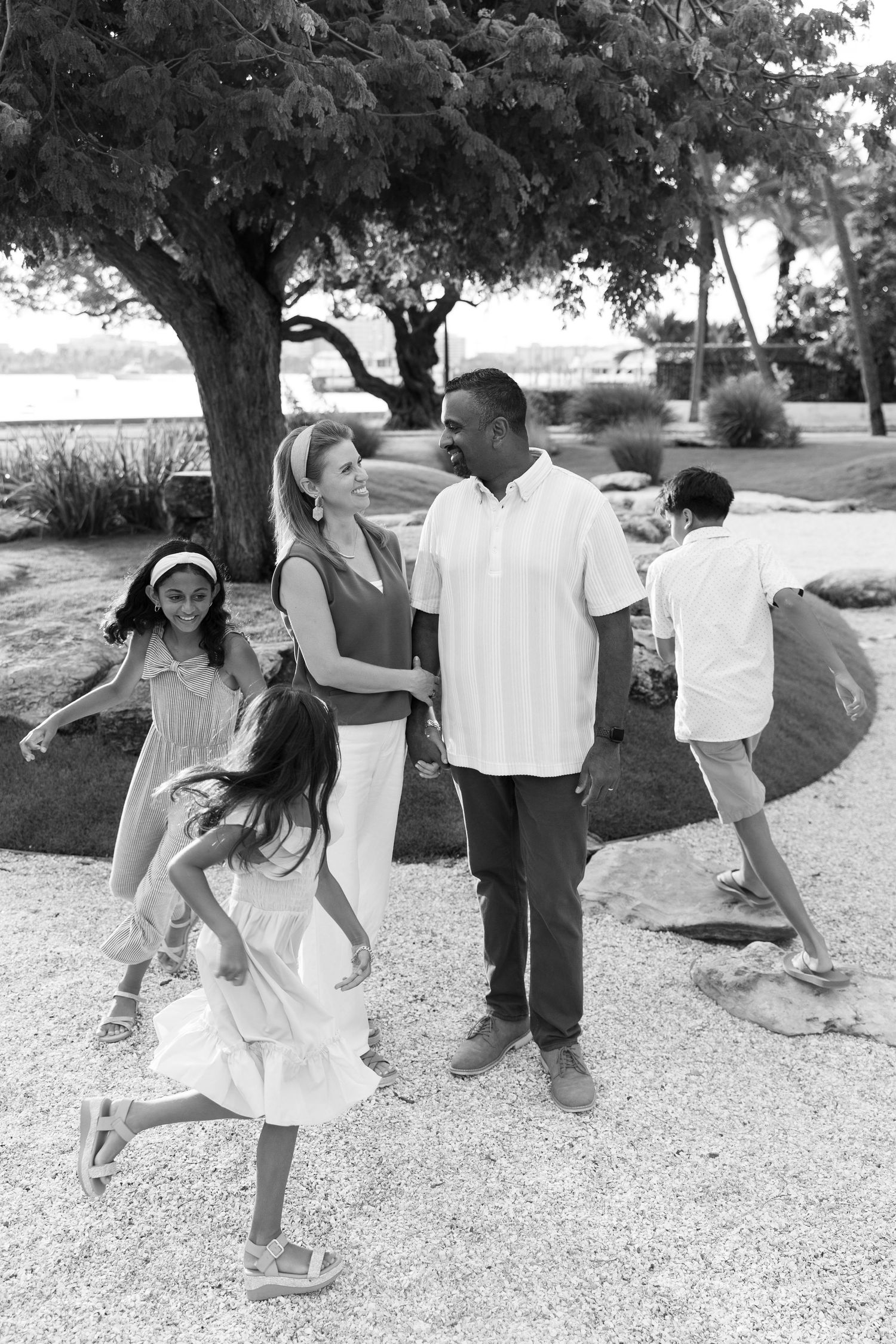 Golden hour summer family photos captured by Lindsay McDow Photography in front of Flagler Museum and in park by water on Palm Beach Island