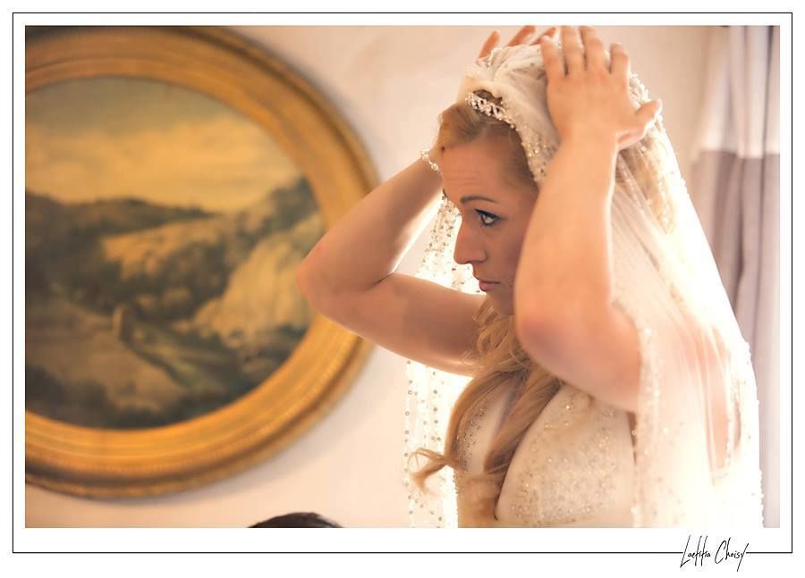 Bride adjusting her veil before the ceremony at Château de Pouget, South of France destination wedding captured in a fine art style