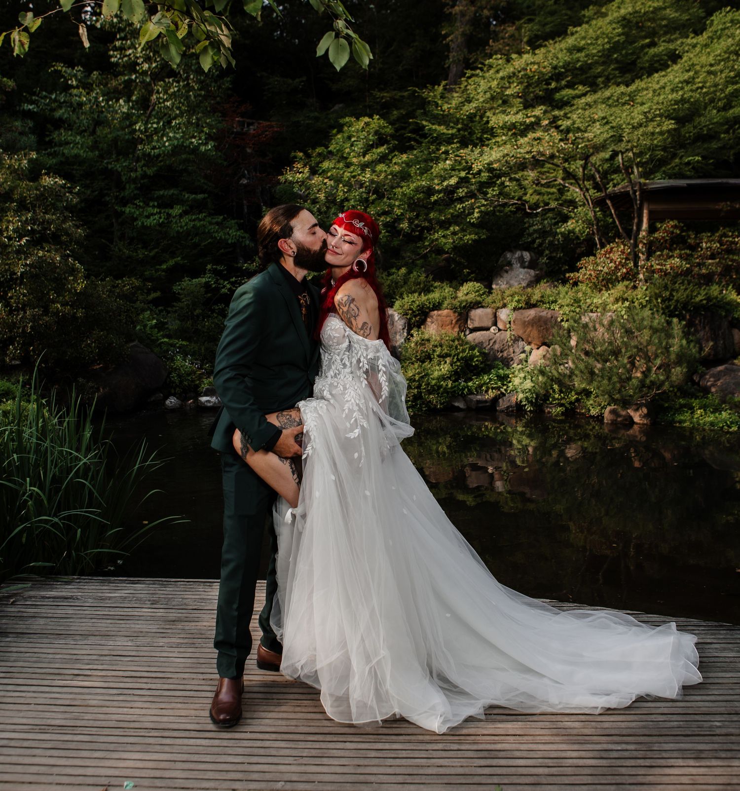 Sunlit forest scene with couple in formal wear between tall trees.