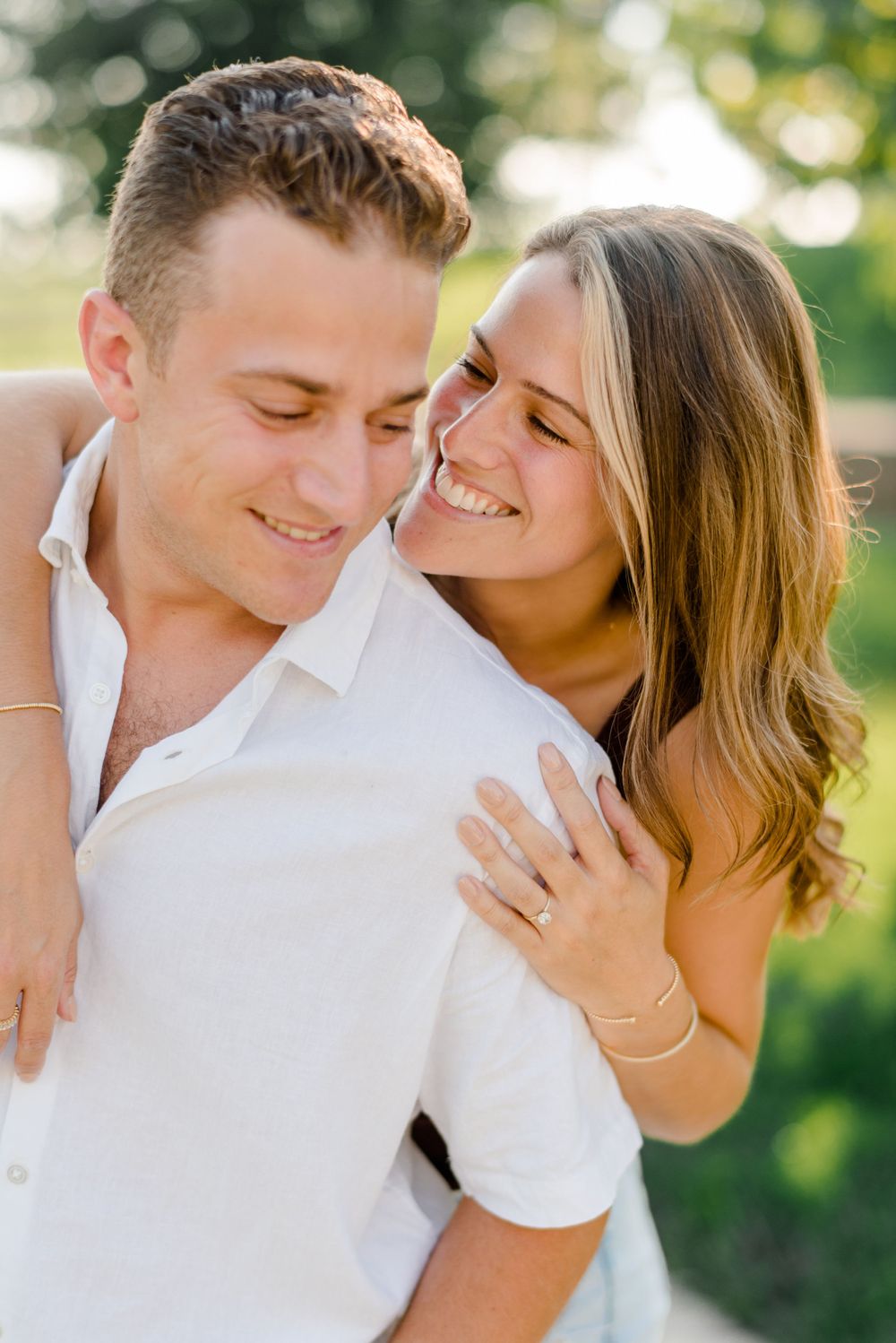 Couple sharing playful moments outdoors in natural sunlight.