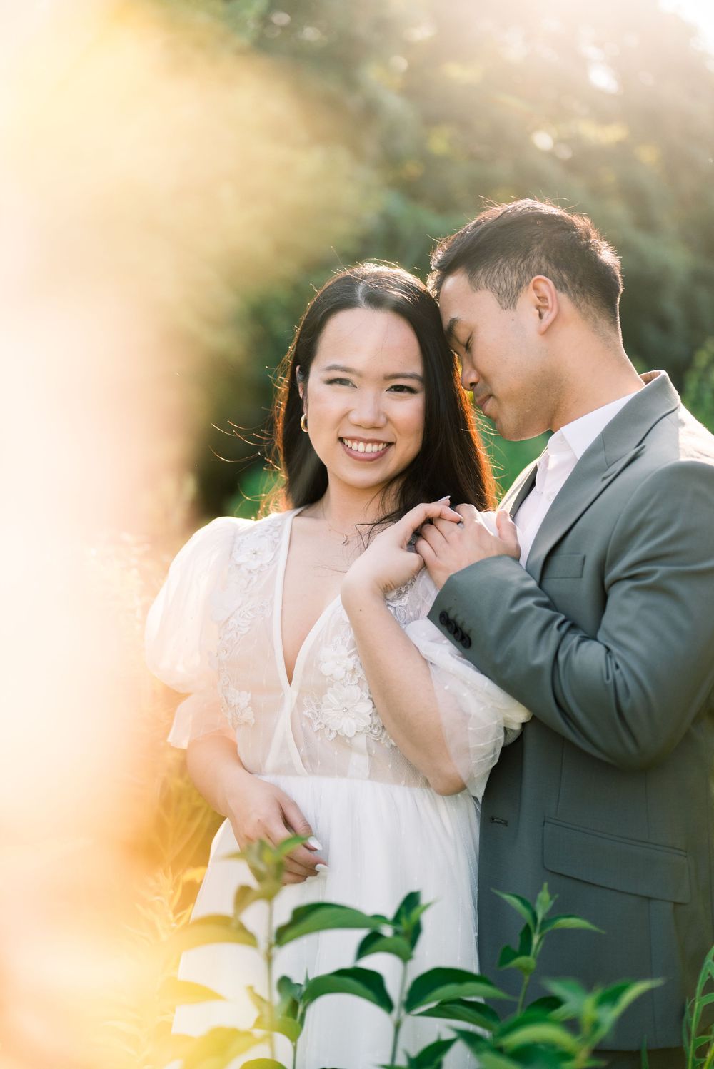 Intimate portrait of couple sharing tender moment in golden sunset light.