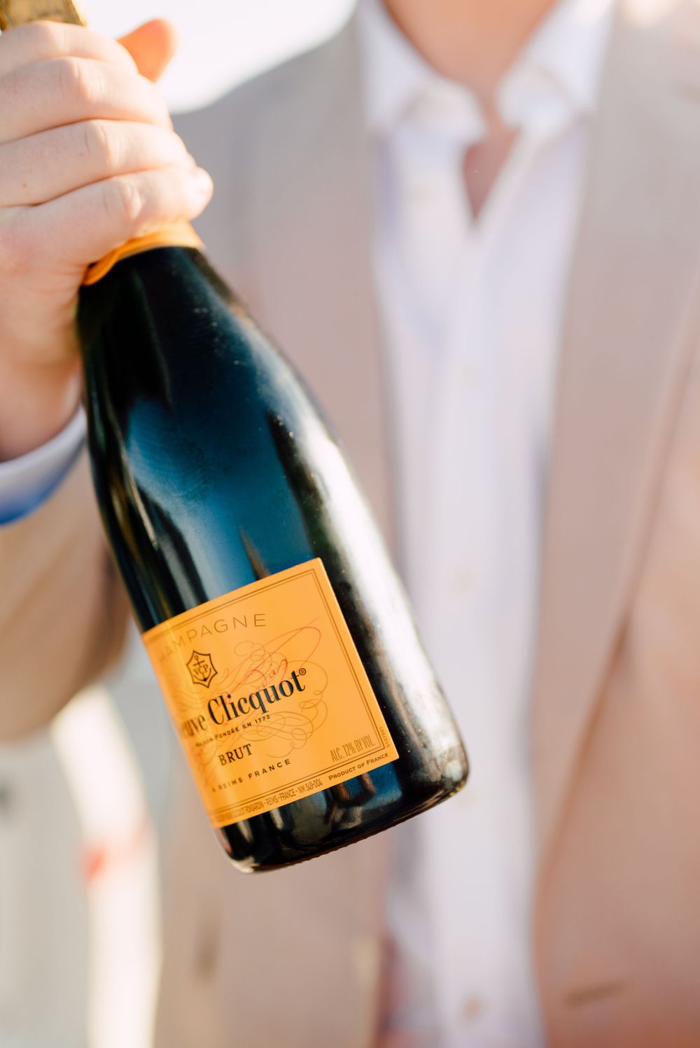 Closeup of Veuve Clicquot champagne bottle with orange label.