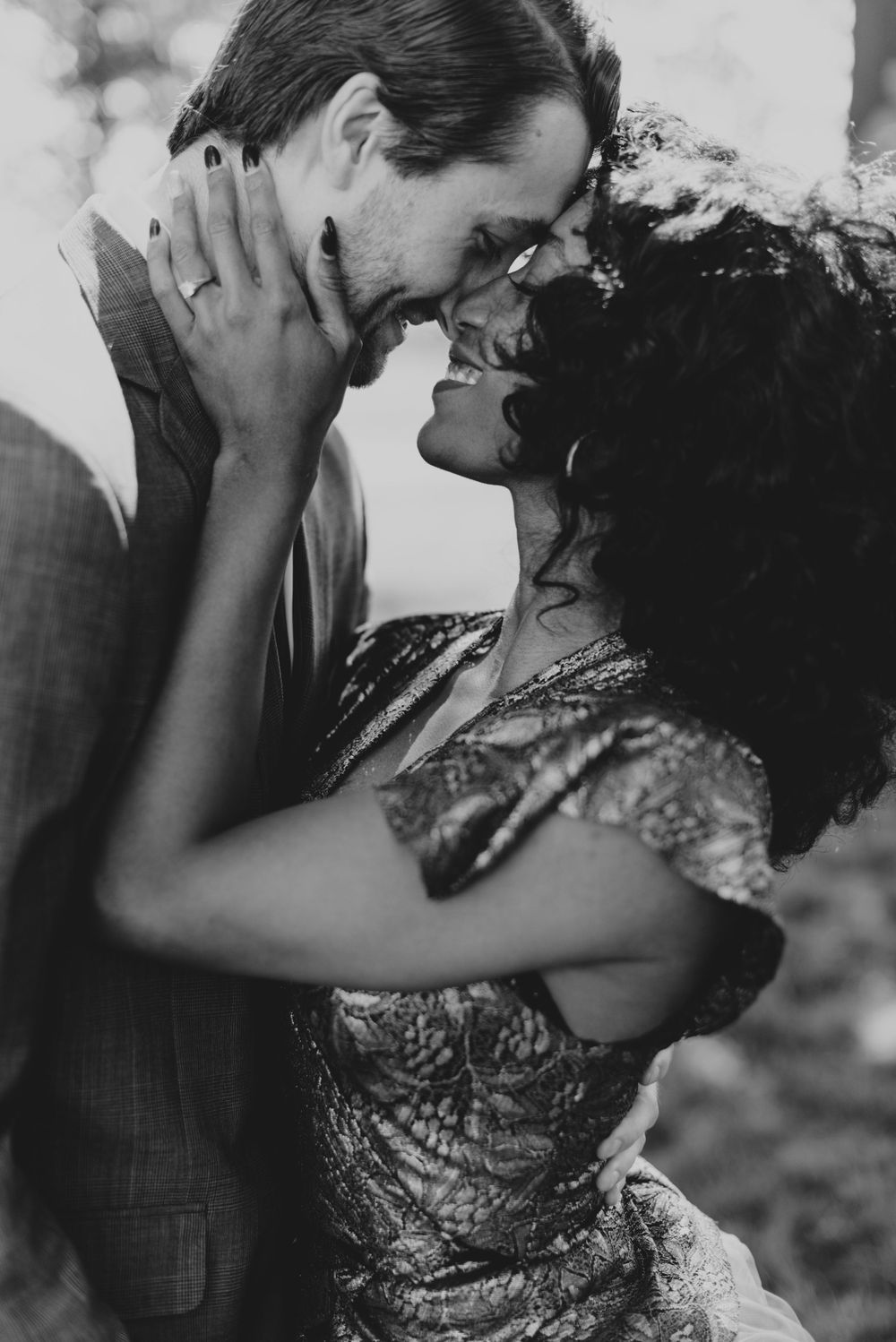 A romantic black and white photo of a couple in an intimate embrace with vintage styling.
