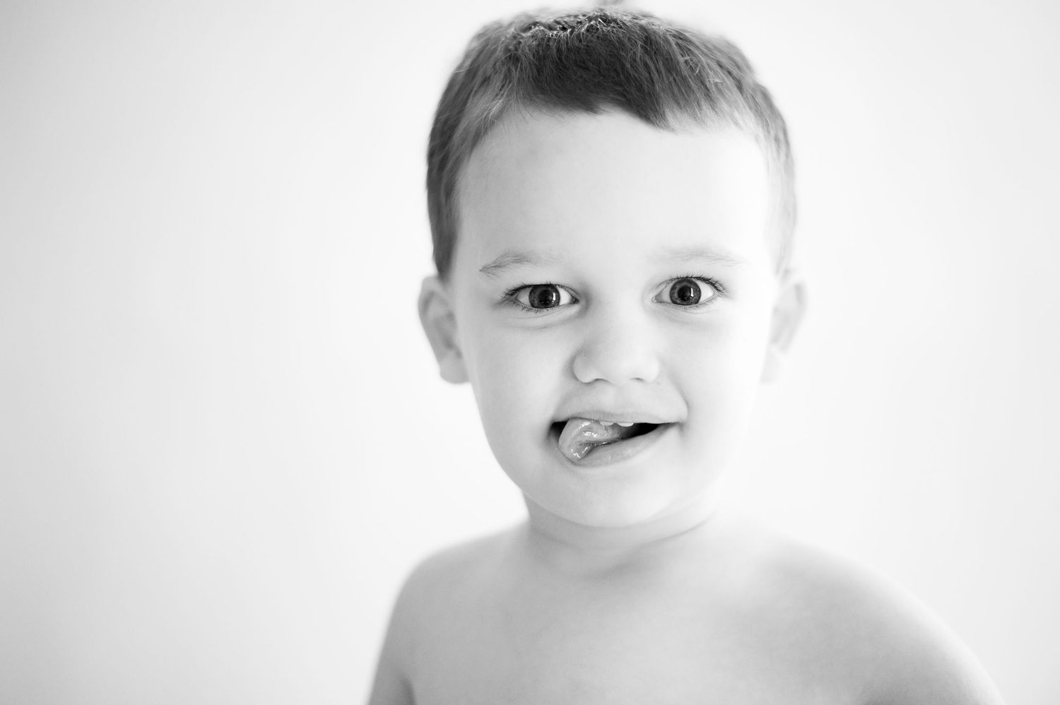 A series of minimalist black and white portraits showing cropped facial features in high contrast lighting.