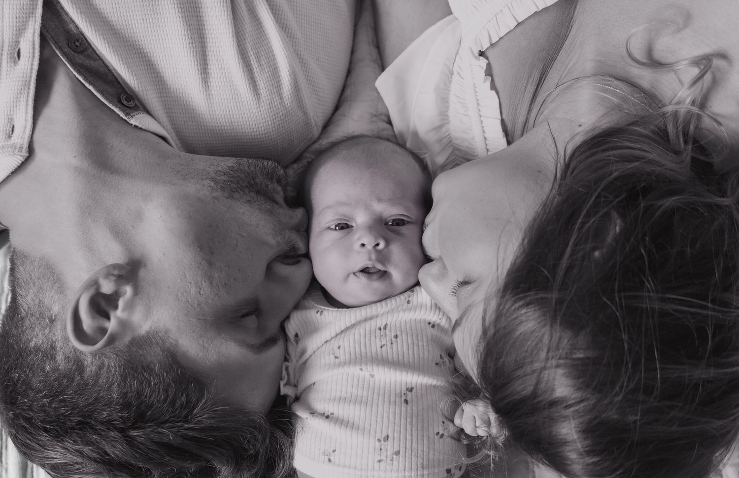 Black and white series capturing intimate moments between parent and baby.