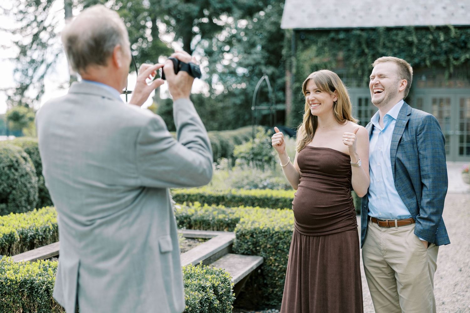 Beautiful outdoor engagement photoshoot session captured in a lush garden setting with green hedges and natural lighting at Ninety Acres.