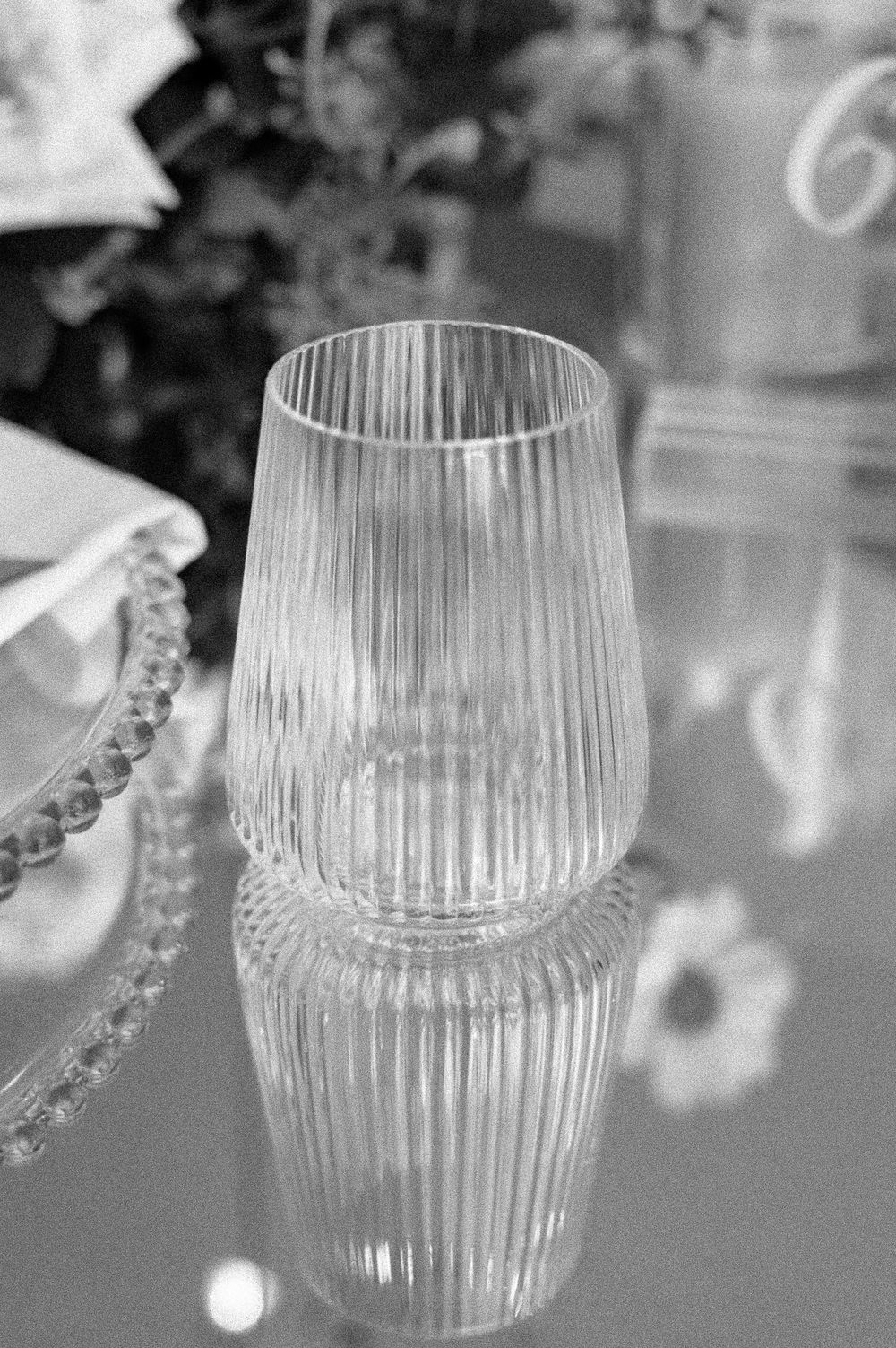 Clear glass vases with ribbed texture shown in sequence displaying elegant concave and curved geometric shapes.