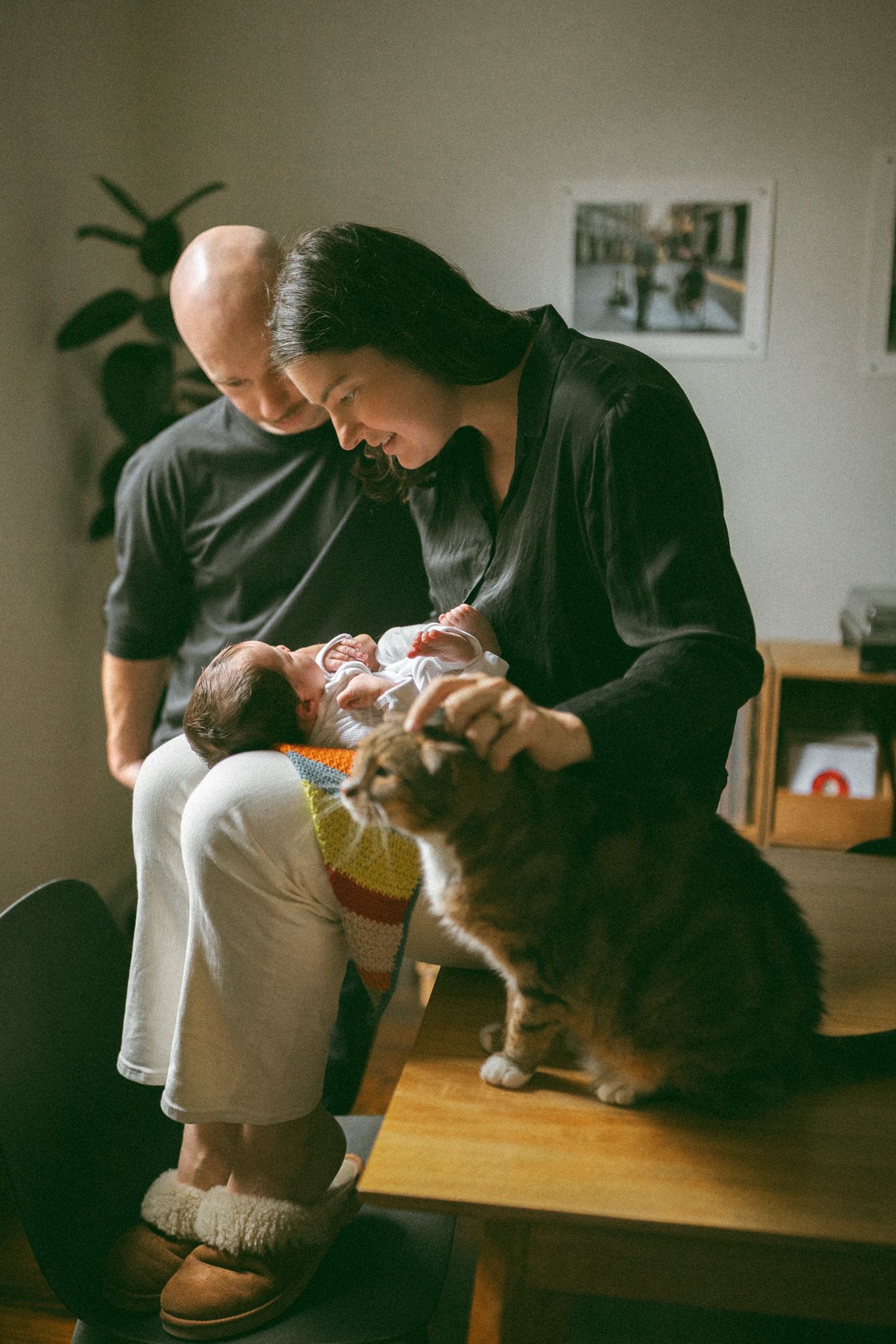 A gentle cradling sequence shows an infant wrapped in a cozy rust-colored knit blanket.