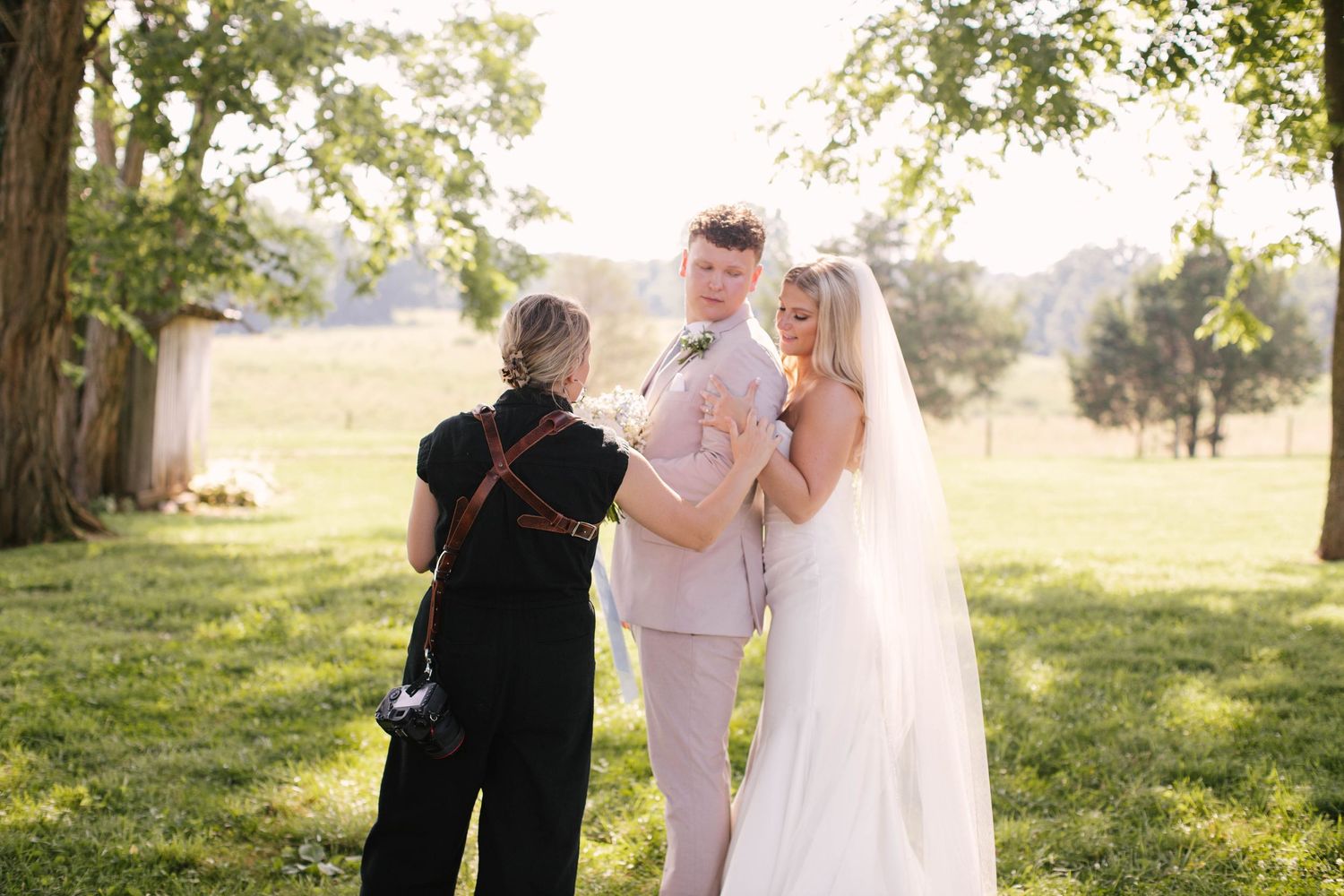 Four black and white images of a couple outdoors sharing intimate moments at their farm wedding ceremony.