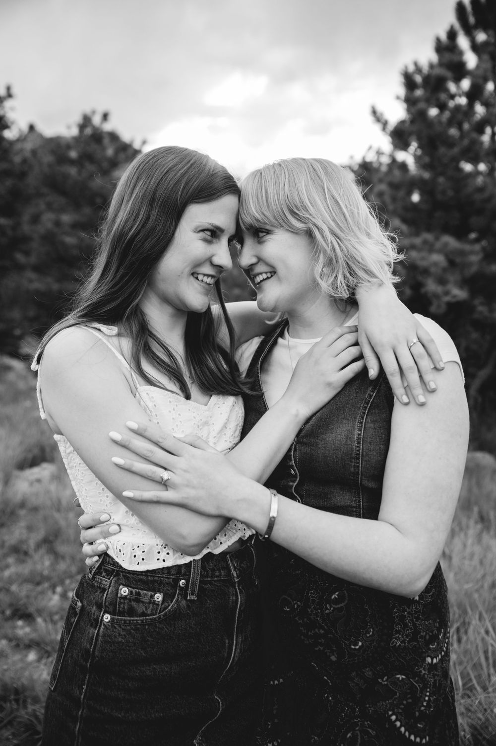 Black and white intimate couple photography series showing tender romantic moments in an outdoor setting.